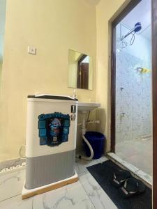 a bathroom with a shower and a sink and a toilet at Guest Favorite 1BDR with Washer, Netflix, Parking & Hot Shower 2547,96,065,022 in Mombasa +15 photos