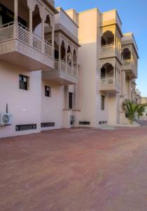 a building with two balconies and a courtyard at Hotel Pushkar Legacy in Pushkar