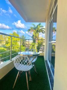 a balcony with a table and chairs and a view of the ocean at Guest Favorite 1BDR with Washer, Netflix, Parking & Hot Shower 2547,96,065,022 in Mombasa