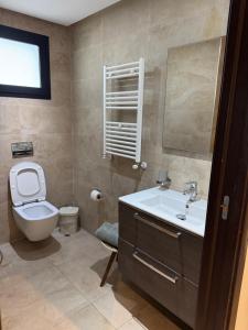 a bathroom with a toilet and a sink and a mirror at L'œil de Fatma in Tunis