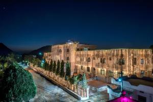 a large building with lights on it at night at Hotel Pushkar Legacy in Pushkar