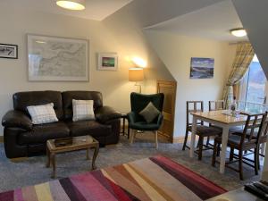 a living room with a couch and a table at Achmore Self catering in Stromeferry