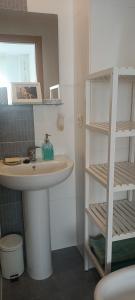 a bathroom with a sink and a book shelf at Luz del Mediterráneo in Moncófar +23 photos