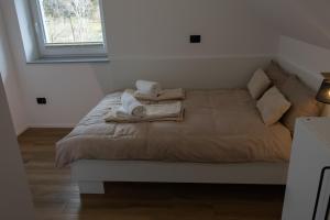 a bed with towels on it in a bedroom at Mahne Apartment in Kranj