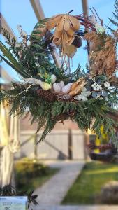 a christmas wreath with a bird on a tree at Casa Stefu in Râşnov