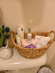 a basket sitting on top of a toilet in a bathroom at Peaceful Oasis steps from Mohegan Sun in Norwich +30 photos