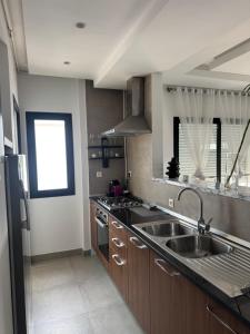 a kitchen with a sink and a counter top at Le David in Tunis +5 photos