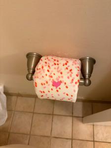 a toilet seat in a bathroom with a toilet paper dispenser at Peaceful Oasis steps from Mohegan Sun in Norwich