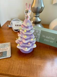 a small christmas tree sitting on a table at Peaceful Oasis steps from Mohegan Sun in Norwich