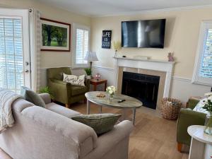 a living room with a couch and a fireplace at Peaceful Oasis steps from Mohegan Sun in Norwich