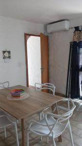 a wooden table and chairs in a room at Refugio del Limonero - Colonial y Cercano in Córdoba +19 photos