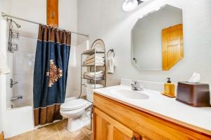 a bathroom with a sink and a toilet and a mirror at Tetro Rock Retreat in Deadwood +31 photos