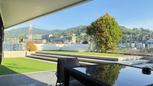 a balcony with a table and a view of a city at 6th Avenue Surin by Win217 in Surin Beach