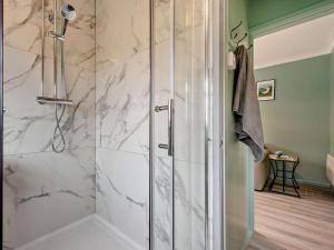 a bathroom with a shower with white marble at 2 Bed in Swansea oc-90367 in Oxwich
