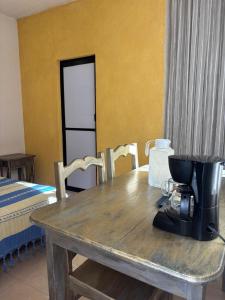 a coffee maker sitting on a wooden table in a room at Tu casa Oaxaca... in Oaxaca City