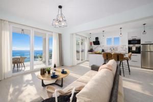 a living room and kitchen with a couch and a table at Villa Leo in Barbati