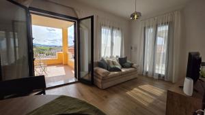 a living room with a couch and a large mirror at Dimora sole e mare in Valledoria