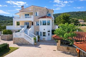 a villa with a view of the mountains at Bella Villa with Private Pool & Sea View Ideal for Groups in Vaia