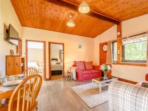 a living room with a red couch and a table at 2 Bed in Pencader oc-89500 in Pencader +12 photos