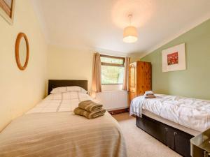 a bedroom with two beds and a window at 2 Bed in Pencader oc-89500 in Pencader