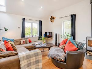 a living room with a couch and a table at 4 Bed in Llandysul oc-93546 in Henllan