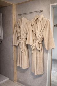 a towel hanging on a wall in a bathroom at Juralodgespa Chalet Emma in Courrendlin +7 photos