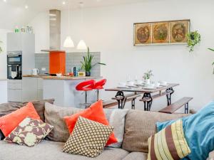 a living room with a couch with colorful pillows at 4 Bed in Llandysul oc-93546 in Henllan