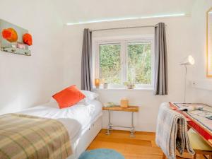 a bedroom with a bed and a window at 4 Bed in Llandysul oc-93546 in Henllan