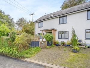 an exterior view of a white house at 4 Bed in Llandysul oc-93546 in Henllan