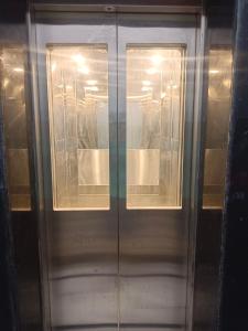 a glass door with two windows on it at Hotel Harihar Atithi Bhawan in Naimishāranya