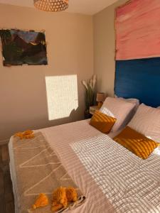a bedroom with two beds and a painting on the wall at Hearttoart in Martigues