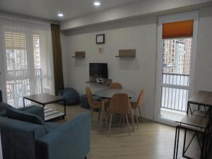 a living room with a couch and a table and chairs at bayern12 in Tbilisi City