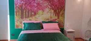 a bedroom with a bed with a painting on the wall at Oasi di san Benedetto in Castellaneta