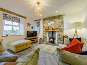 a living room with a couch and a fireplace at 3 Bed in Llandysul oc-90019 in Llandyssiliogogo