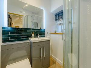 a bathroom with a sink and a glass shower at 3 Bed in Llandysul oc-90019 in Llandyssiliogogo +31 photos