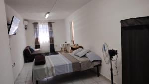 a bedroom with a bed and a chair in it at Central and Comfortable Accommodation 4 in Altamira