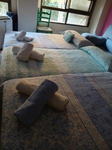 two beds with pillows on them in a room at Habitaciones Castellon in Castellón de la Plana