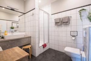 a bathroom with a toilet and a sink at Pension Onken in Bockhorn +49 photos