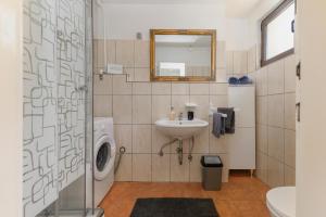 a bathroom with a sink and a washing machine at Casablanca-Brgulje in Brgulje +23 photos