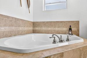 a large white bath tub in a bathroom at Steps to beachTiki BarHeated Poolfun! in Clearwater Beach