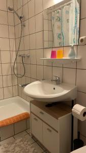 a bathroom with a sink and a shower and a tub at Cafe Gaubenhaus in Bad Fallingbostel +26 photos