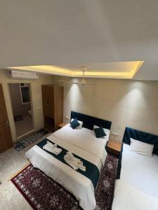 a hotel room with two beds with towels on them at Hotel Classio Ali Asgar in Jaorā