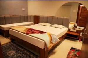 a bedroom with two beds in a room at Hotel Classio Ali Asgar in Jaorā