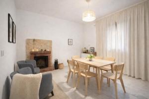 a dining room with a table and chairs and a fireplace at Salerno casa con jacuzzi privata e cinema in Salerno