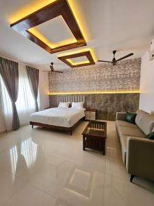 a bedroom with a bed and a couch at YR sea resort in Pāmban