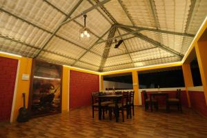 a dining room with a table and chairs at YR sea resort in Pāmban