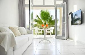 a living room with a white couch and a table with oranges on it at ALBACHIARA INN Residence Apartments in Ameglia