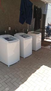 a group of three toilets sitting on the ground at Loft Murano in Paulínia