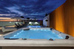 a jacuzzi tub sitting on top of a building at AZURE Seaside Residence in Kokkini Khanion