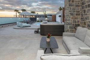 a living room with a couch and a tub at AZURE Seaside Residence in Kokkini Khanion
